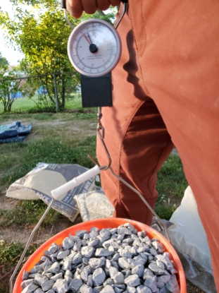 It takes about 1.6 bags of gravel to fill a bucket to 75 lbs